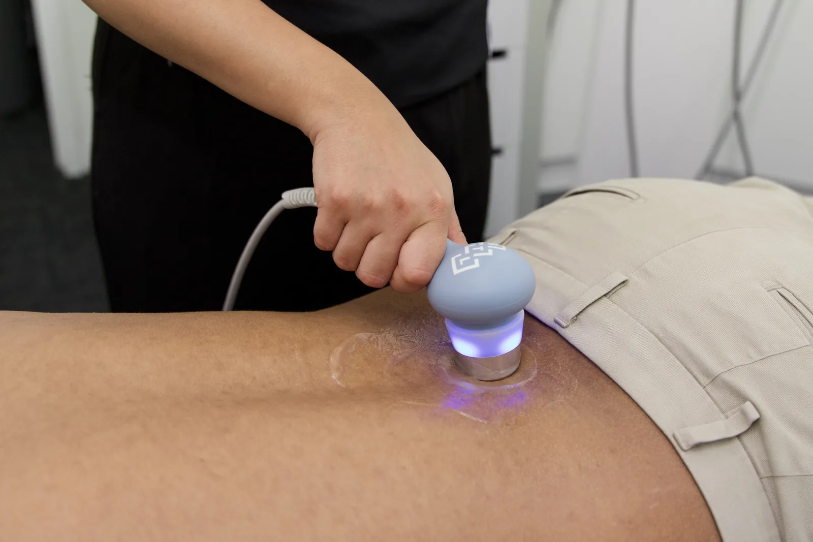 Therapeutic ultrasound being applied to a patient's lower back