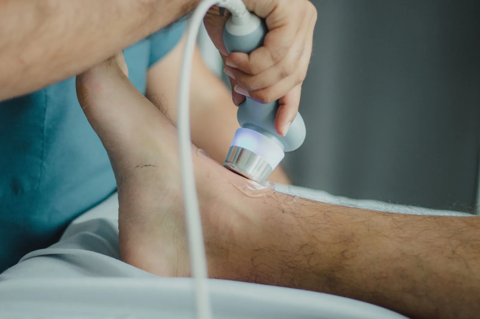 Therapeutic ultrasound being applied to a patient's ankle