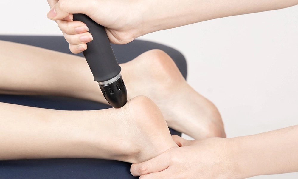 Shockwave therapy being applied to the heel and Achilles tendon