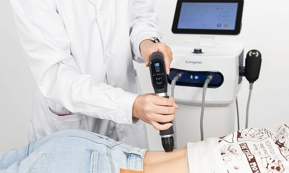 The Longest PowerShocker LGT-2500X shockwave therapy machine with its handpiece and touchscreen